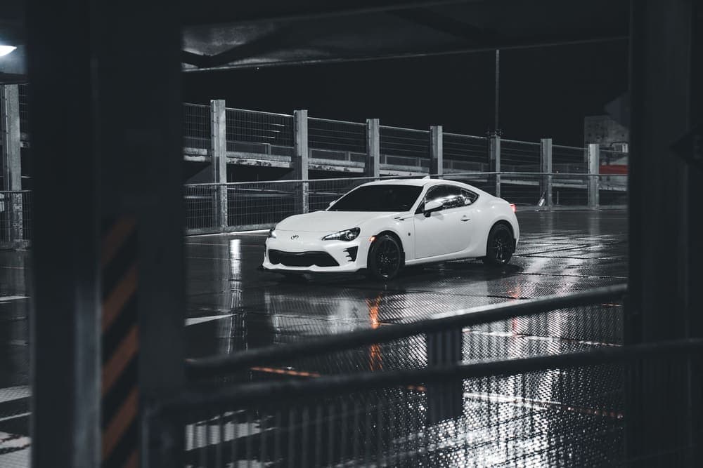 Sports car parked in a car park at night