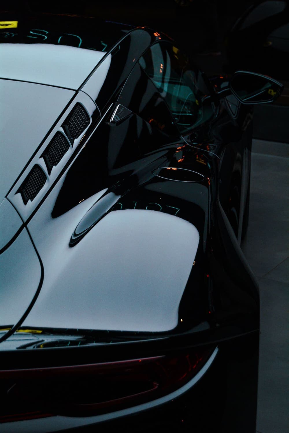 Deep gloss on a black sports car